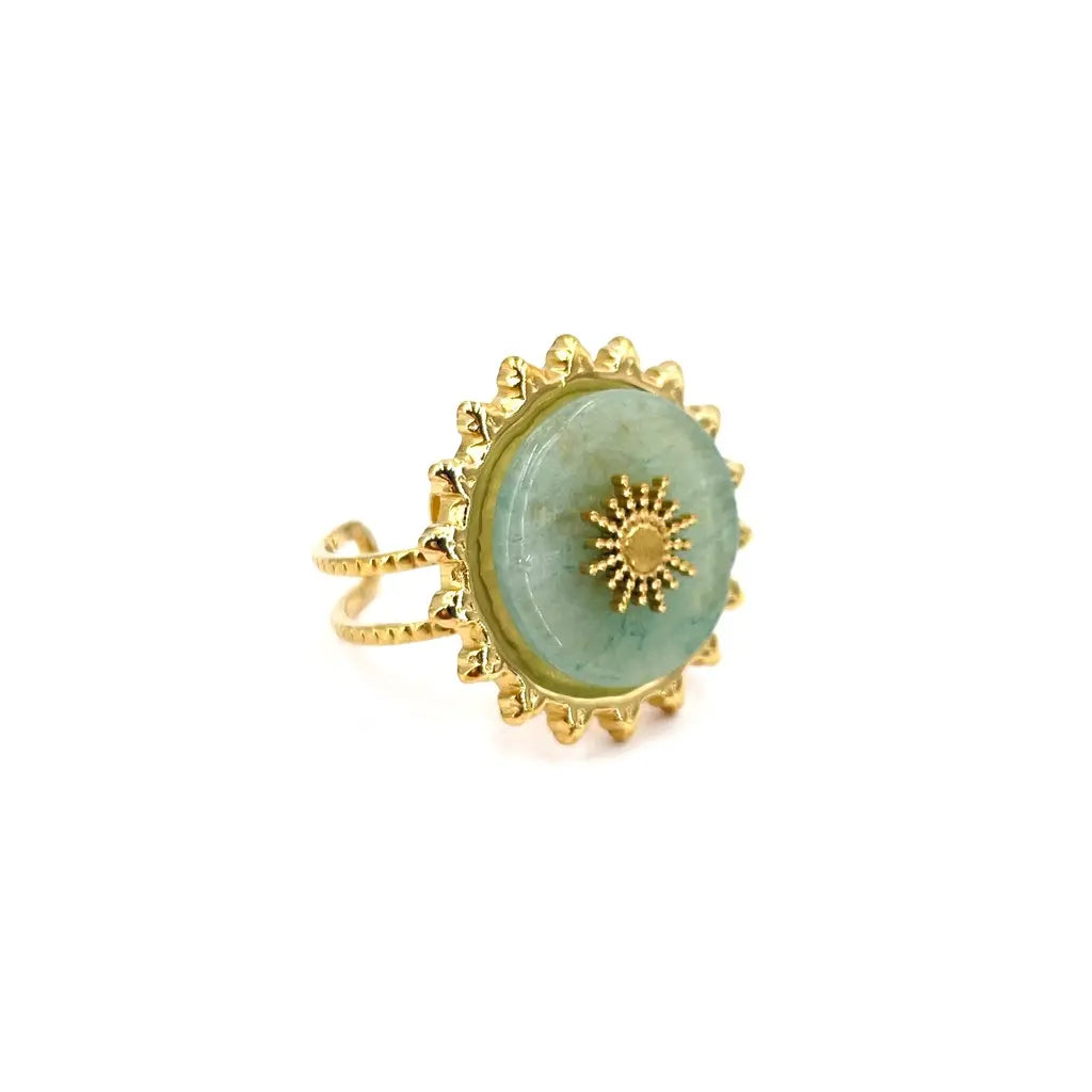 Bague ronde turquoise avec un motif en forme de soleil au centre