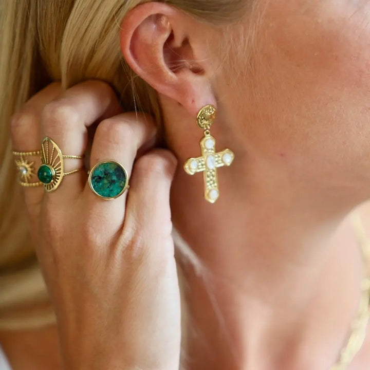 Bague pierre ronde en acier inoxydable doré ornée d'une pièce ronde sertie d'une pierre naturelle turquoise africaine portée au doigt