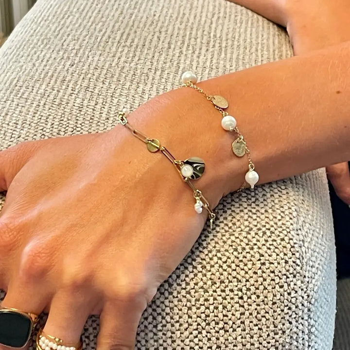 Bracelet à maillons en acier inoxydable doré avec perles d’eau douce, pierre white opale et pampilles ondulée porté au poignet (2)